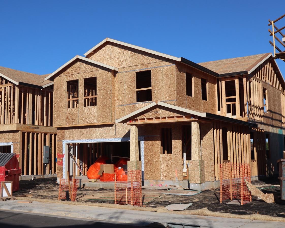 A two-storey house framed and sheathed, ready for roofing and windows