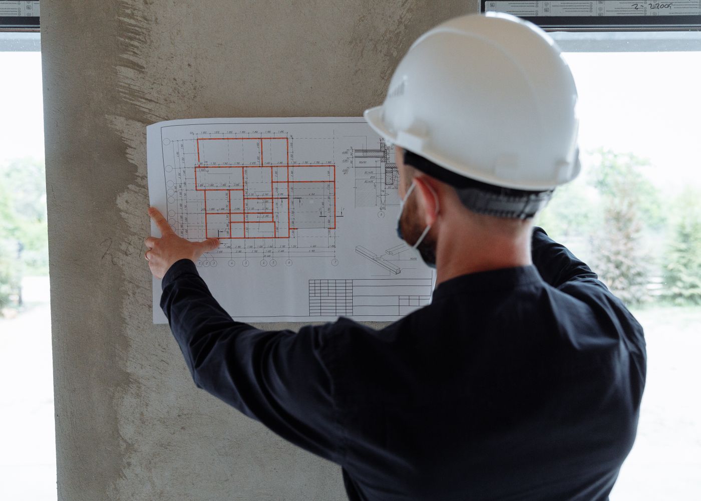 Superintendent reviewing floor plans on a Khella job site