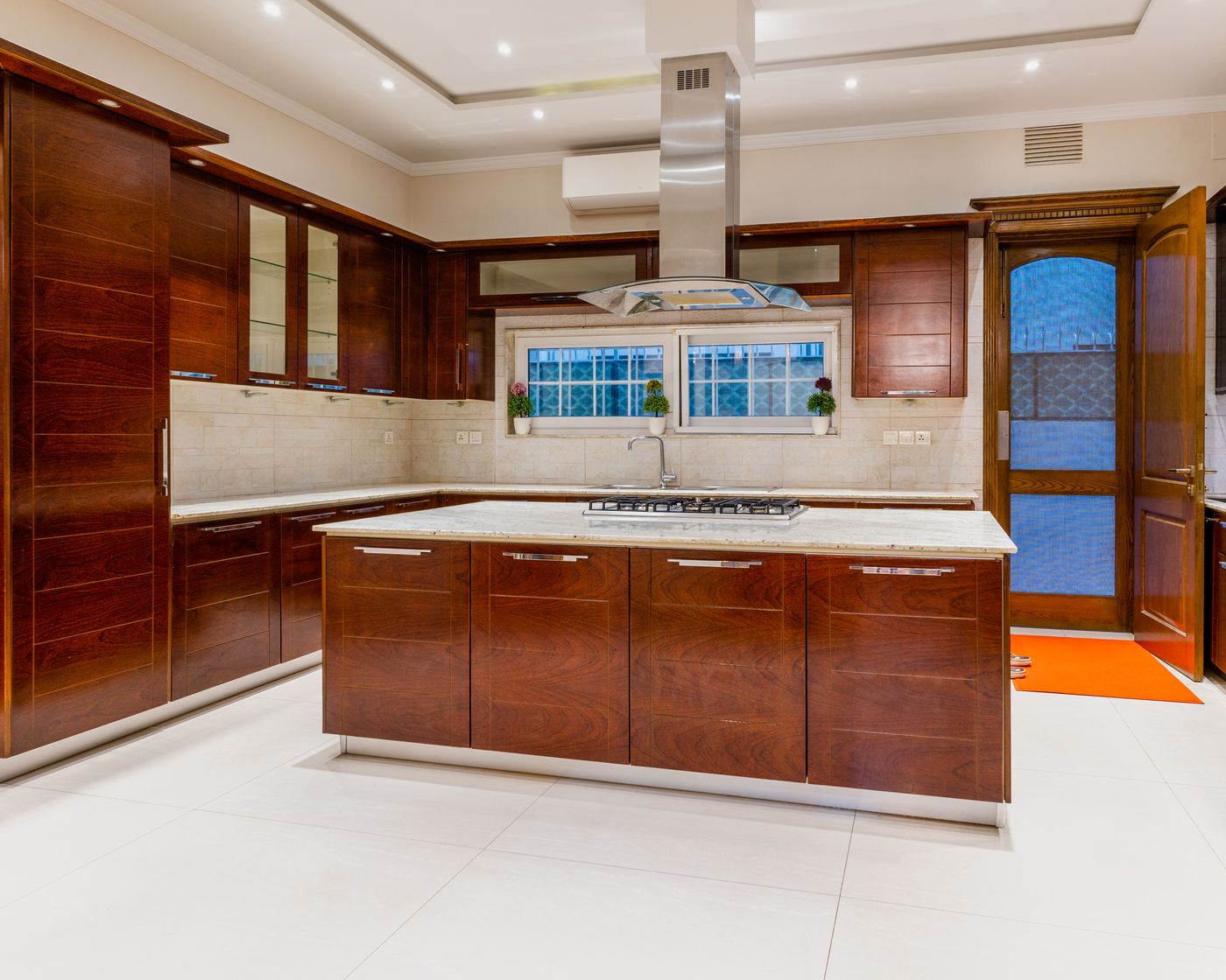 Renovated kitchen with island, marble counters and custom cabinetry