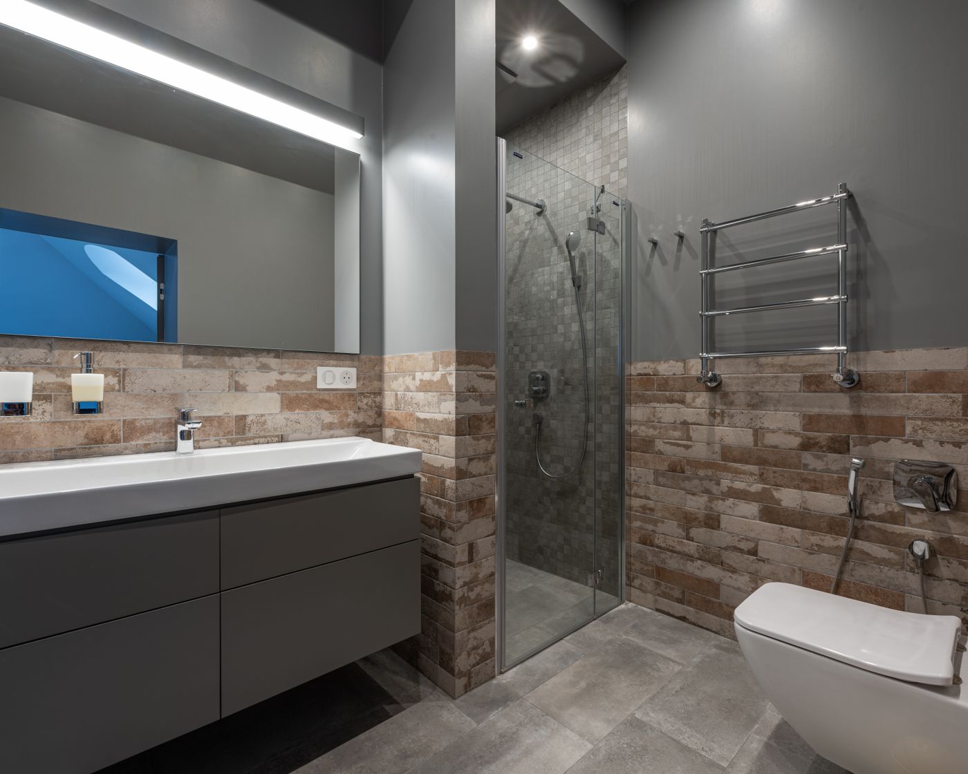 Renovated bathroom with walk-in shower, tiled walls and floating vanity