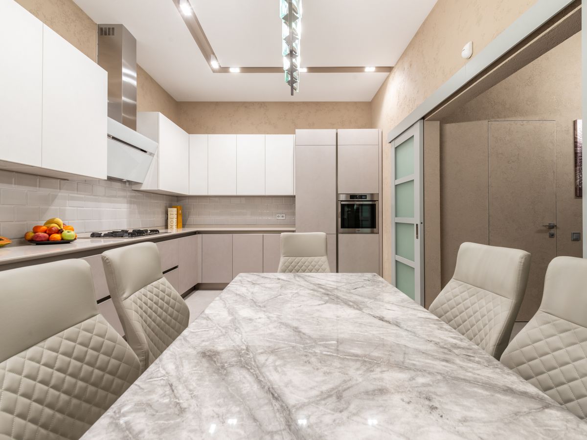 Renovated kitchen with island, stone counters and custom cabinetry